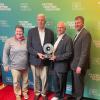 Angie Gilbert, Dave Newport, Jamie Zaninovich and Jason Depaepe receiving an award