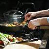 Person cooking food in a frying pan