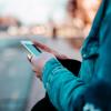 Person checking their phone while walking
