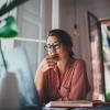 person thinking about something while sitting at a computer