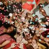 Group of young people, laying in a circle on the ground at a holiday party
