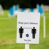 a sign that says keep your distance