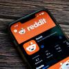 Photo of a smartphone with the screen displaying the Reddit app in a store