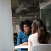 Two women sitting at a table and talking