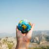 person holding globe out