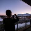 A visitor to the Aerospace Building takes a photo of the view during sunset