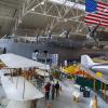 Visitors look at planes at the Wings Over the Rockies Air and Space Museum