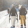Group of friends walking with snowshoes in hand