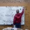 Student works on math problem on white board