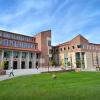 The CU Boulder Art Museum in the summer with people walking by, down the sidewalk.