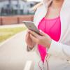 Woman checks smartphone app before going on a run