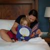 Caregiver and child sitting in bed reading bedtime story