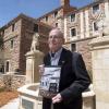 Campus Architect Emeritus Bill Deno poses for photo with Body & Soul book