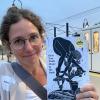 Erin Block poses with her book of poetry