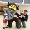 CU employee and children pose for a photo with Chip the Buffalo at the Rec Center