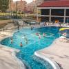 Students playing volleyball and swimming in the Buff pool on campus