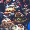 People make plates of food at a potluck