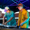Two people mixing music