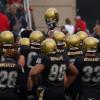 Buffs football players gather before a game.