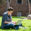 student working on laptop outside