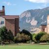 People walk with a dog near Williams Village.  (Photo by Patrick Campbell/University of Colorado)