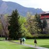 Students walk on campus with umbrellas during a spring rain