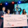 Double Helix group poses for photo with giant million-dollar check