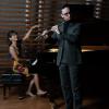 Kaleb Chesnic playing flute and Nathália Kato playing piano