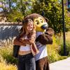 Chip the buffalo mascot poses with a new student on campus