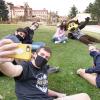 Students gather for a selfie with Chip the buffalo mascot outside 