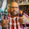 Christopher Bell poses with Gamora and Black Widow action figures