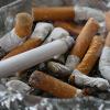 A dirty ashtray full of cigarettes