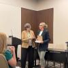 Doctoral student Ashley Carter accepting the first place award for best paper