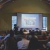 Conference attendees watch a presentation