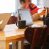 People work on laptops in cafe