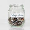 Stock image of a money jar labeled "College Fund"