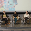 Featured speakers sit in a panel to take questions
