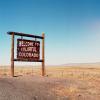 The 'welcome to colorful colorado' sign stands along a Colorado highway.