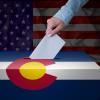 Person drops ballot in a drop box
