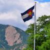 Colorado flag with Flatirons in the background