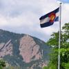The majestic Flatirons provides a backdrop to the Colorado State Flag at the University of Colorado Boulder. (Photo by Casey A. Cass/University of Colorado)