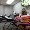People receive treatment in a community acupuncture room with recliners.