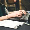 Woman types on laptop