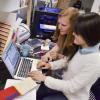 Students work at laptop computer