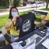 Volunteers pass out Sko Buffs t-shirts during move-in