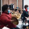 students wearing masks while playing brass and wind instruments 