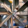 Maintenance worker viewed through a ventilation fan.