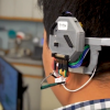 A man wears an early prototype for the "Earable" device over his head.
