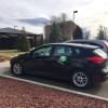 A Zipcar is parked on campus.