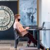 student working on laptop on campus